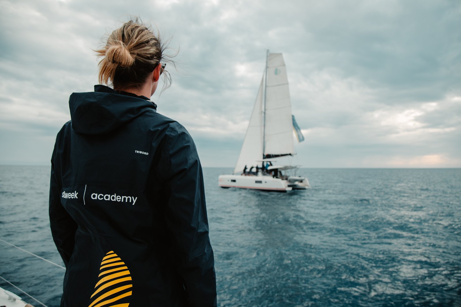 Academy participant watching sailing boats from the deck