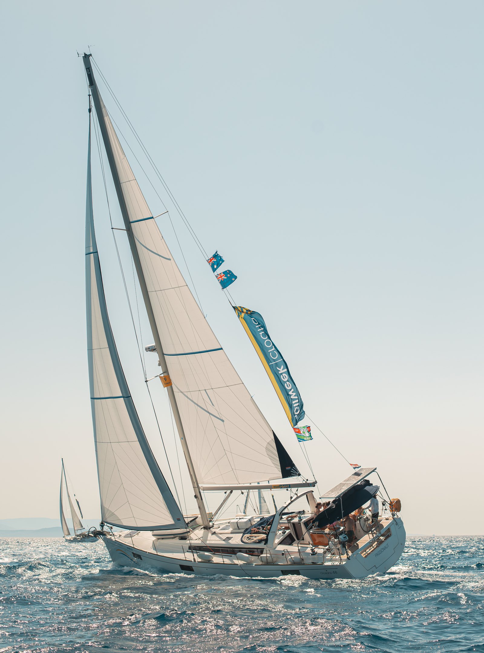 Yacht sailing under SailWeek flags off the Croatian coast